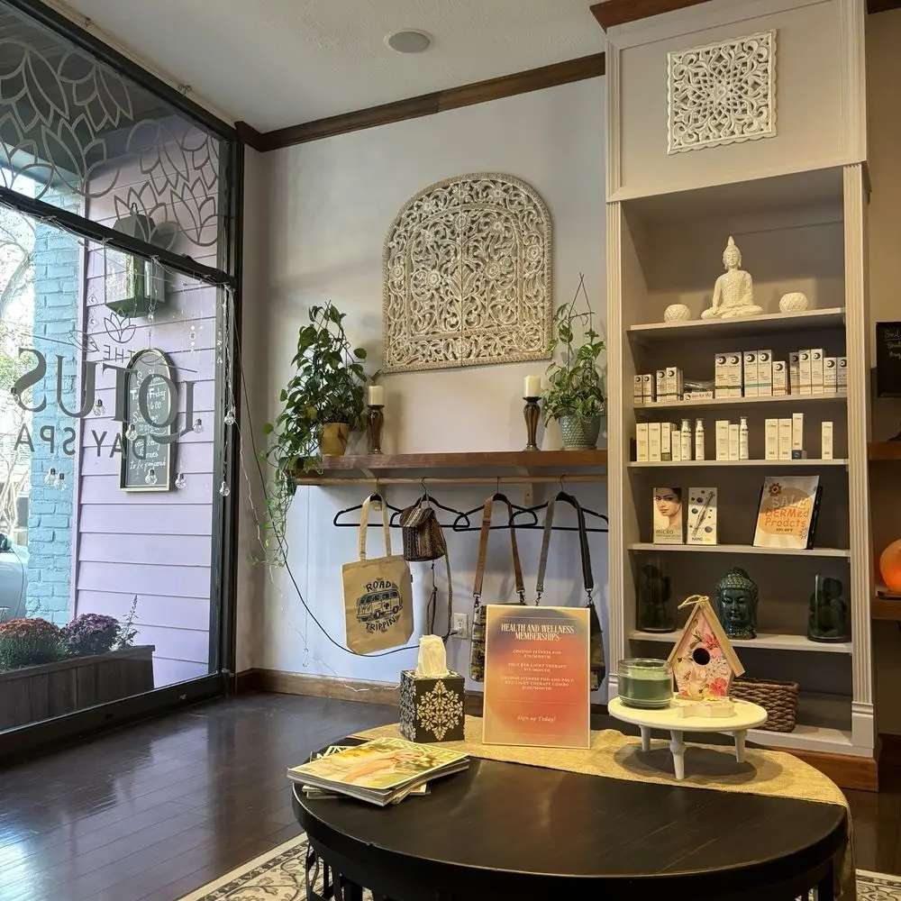 The serene interior of The Lotus Day Spa in downtown Hattiesburg — soft lighting, treatment room, candles